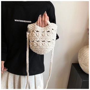 Detailed view of bohemian hand-woven knit bag with hollow diamond pattern and braided strap