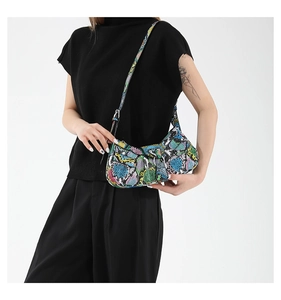 Detail of multi-color snakeskin print PU leather hobo bag with silver metal buckles