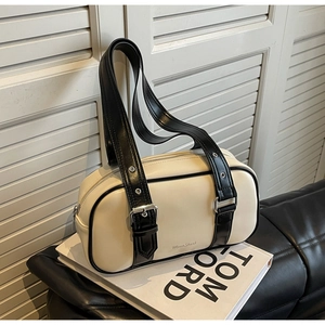 Minimalist cream white PU leather bowling bag with black trim and adjustable eyelet straps