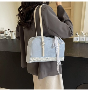 Detail showing the light blue PU shoulder bag with floral trim and lace bow decoration