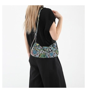 Detailed back view of a colorful snakeskin pattern hobo shoulder bag worn by a model
