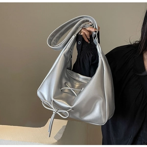Detailed view of silver metallic PU Hobo bag with stylish bow and drawstring design