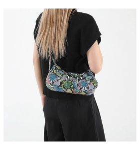 Close-up of vibrant snake skin pattern and silver metal buckle on the PU shoulder bag