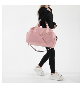 Detail view of the pale pink waterproof nylon fabric bag with adjustable shoulder strap