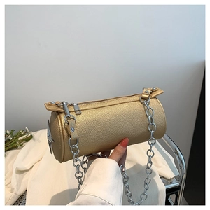 Champagne gold PU leather cylinder bag with star metal trim and silver chain strap