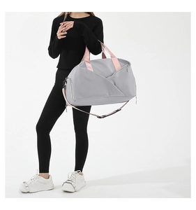 Side view of grey fitness bag showing separate shoe compartment and pink nylon straps
