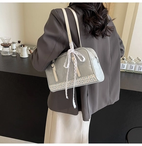 Detail of silver PU leather bag with blue floral fabric and white lace strap decoration