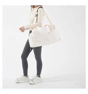 Close-up of a large capacity cream nylon crossbody bag with adjustable shoulder strap