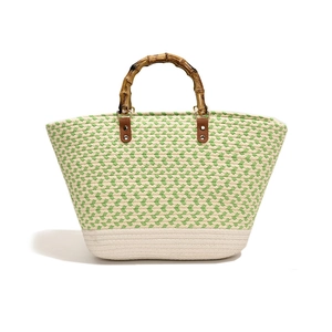 Green and beige woven tote bag with bamboo handles and wave texture for spring fashion