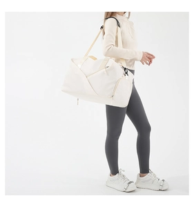 Detail shot of a versatile off-white nylon crossbody bag for sports and travel