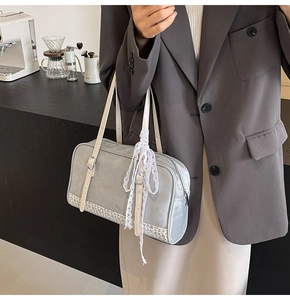 Detail view of a gray PU shoulder bag with white lace ribbon and vintage floral base