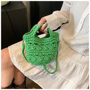 Detail of bright green knit crossbody bag showing handcrafted crochet texture and weave