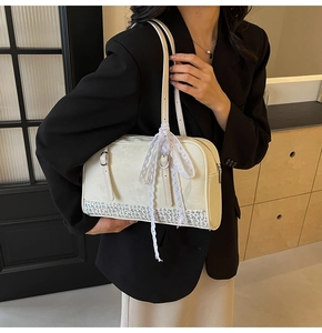 Detail view of cream PU shoulder bag featuring floral patchwork and white lace ribbons