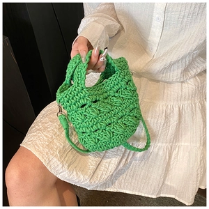 Detail of lime green hand-knitted crossbody bag with 3D texture and silver hardware