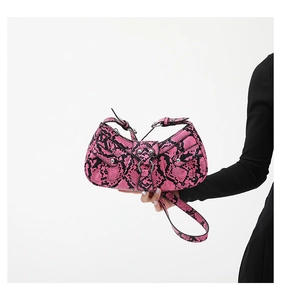 Detail of pink snakeskin pattern PU leather hobo bag with metal ring buckle and rivets
