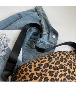 Detail of leopard print canvas crossbody bag with adjustable wide nylon shoulder strap