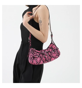 Detail of pink python texture PU leather crossbody bag with silver studs and buckles