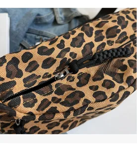 Macro close-up showing the smooth black nylon zipper and leopard print fabric detail