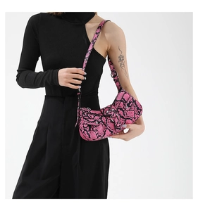 Close-up of pink snakeskin pattern shoulder bag with silver hardware detail