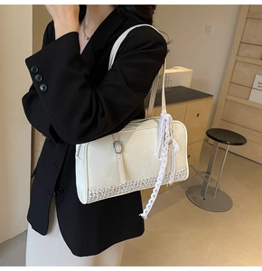 Close-up of cream PU shoulder bag featuring floral patchwork and delicate lace bow detail