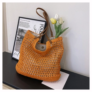 Chic orange woven crochet tote bag with brown leather straps and magnetic closure