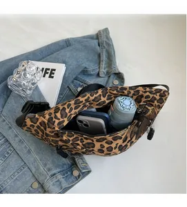 Detailed interior of leopard print canvas cross-body bag showing spacious storage capacity