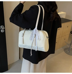 Detail of cream white PU leather bag with floral trim and white lace bow accessory