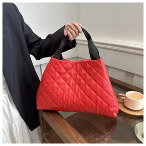 Détail du sac cabas rouge matelassé en cuir PU avec anses en toile noire en scène de vie