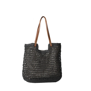 Minimalist black woven tote bag with brown leather handles and metal rivet details
