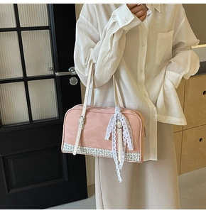 Pink faux suede handbag with floral pattern bottom and delicate white lace bow detail