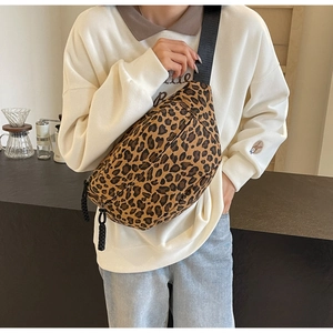 Close-up of leopard print crossbody bag featuring durable canvas and wide nylon strap