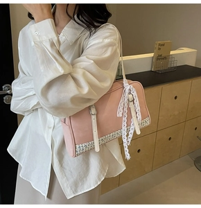 Pink PU crossbody bag featuring floral fabric patchwork and delicate white lace bow detail
