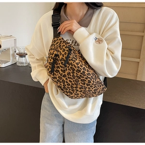 Fashionable leopard print crossbody chest bag shown on model in a casual lifestyle setting