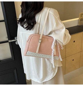 Detailed view of pink floral patchwork PU bag with lace trim and slim white shoulder straps