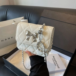 White quilted PU shoulder bag with silver bow accent and metal chain strap for women