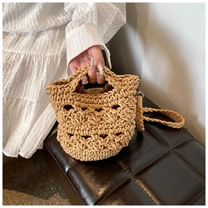 Detail of hand-woven knitted shoulder bag with textured rope patterns and crossbody strap