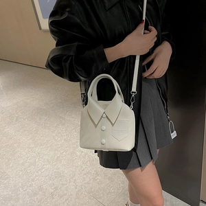 Minimalist white shirt-shaped bucket bag with collar details and buttons on crossbody strap
