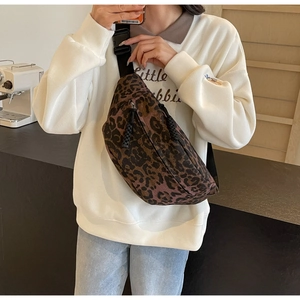 Detail of leopard print crossbody bag showing large capacity and adjustable nylon strap