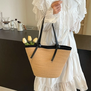 Large capacity straw woven tote bag with black trim and leather straps for beach holidays