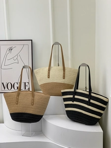 Three woven straw tote bags in various color combinations with faux leather handles