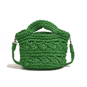 Grass green handmade crochet knit crossbody bag with thick woven texture and silver hardware