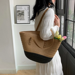 Detail of the woven texture and contrast stitching on this straw patchwork tote bag