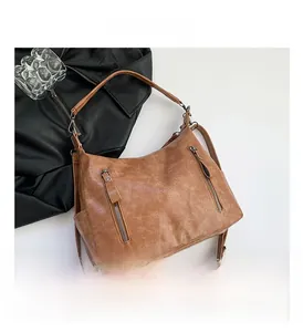 Detail view of brown vintage shoulder bag with textured PU leather and zipper accents