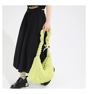 Detail of green popcorn textured bag showing bubble fabric and drawstring closure
