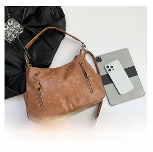 Macro shot showing large capacity of vintage brown tote bag with iPad for size reference
