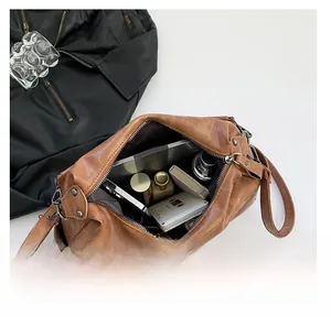 Top view of brown vintage shoulder bag showing large interior capacity for daily items