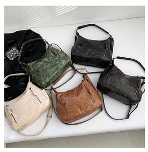 Detailed overhead view of vintage-style leather shoulder bags in five classic colors
