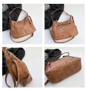 Detail view of retro caramel PU leather bag showing multi-pocket zippers and textured finish