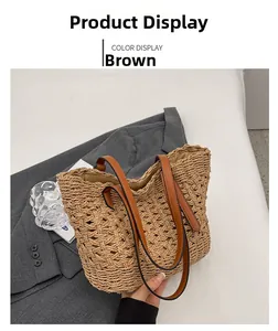 Detail view of a brown woven straw shoulder bag with dark brown leather handles