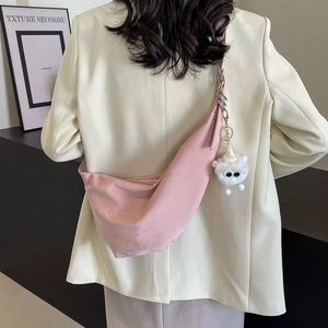 Chic pink crescent hobo shoulder bag with a cute plush charm and silver hardware